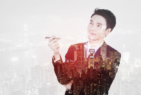 Double exposure of  business man thinking against the cityの写真素材