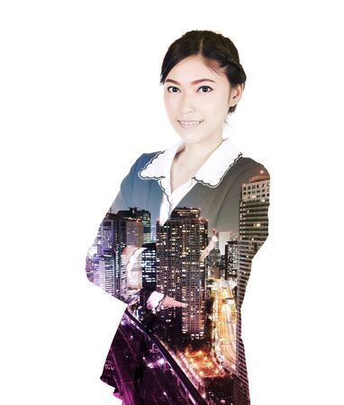 Double exposure of business woman standing with her arms crossed against the city isolated on white backgroundの写真素材