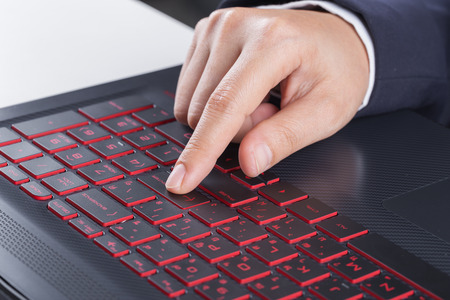 finger pushing enter button on a laptop keyboardの写真素材