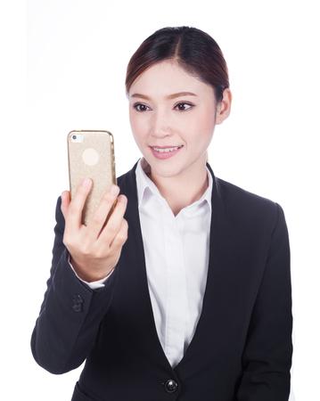 Happy business woman taking selfie photo with smartphone isolated on white backgroundの写真素材