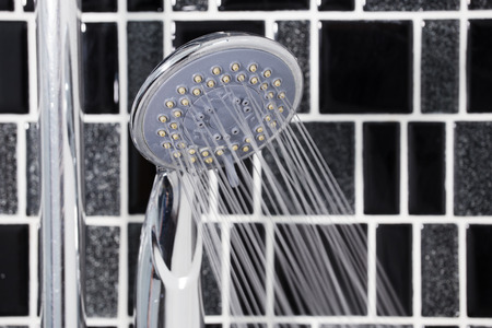 shower head in the bathroom with water drops flowing