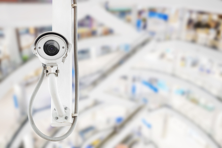 CCTV security camera with blurred shopping mall background