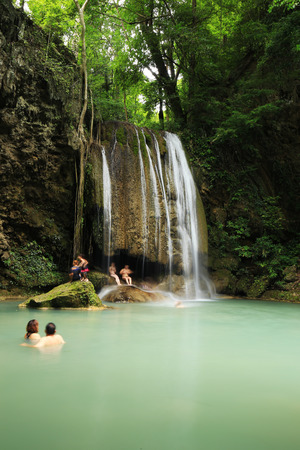 KANCHANABURI, THAILAND - JUNE 24: People traveling and bath in Erawan waterfall, Thailand on June 24, 2017のeditorial素材