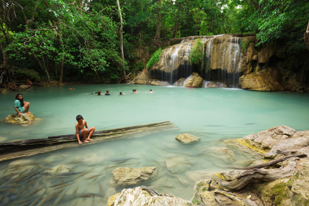 KANCHANABURI, THAILAND - JUNE 24: People traveling and bath in Erawan waterfall, Thailand on June 24, 2017のeditorial素材