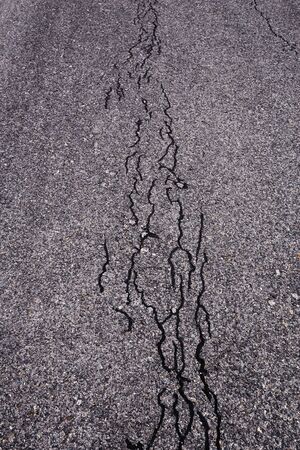 closeup of cracks of asphalt road