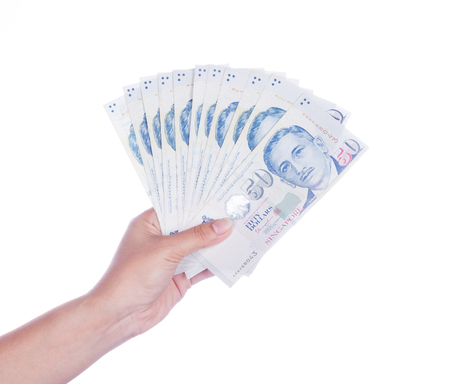 hand with Singapore banknotes dollars (50 SGD) isolated on a white backgroundのeditorial素材