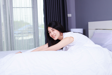 beautiful woman on bed in the bedroomの写真素材
