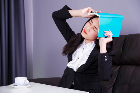 frustrated business woman with a bookの写真素材