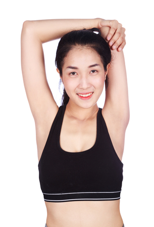 Fitness woman stretching the muscles of her arms isolated on a white backgroundの写真素材