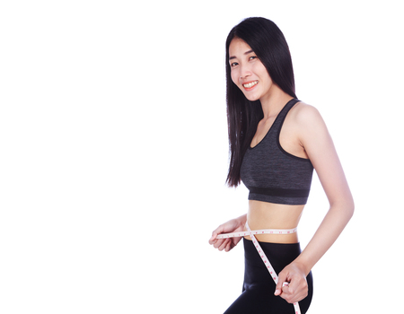 woman measuring waist with tape isolated on white background (diet concept)の写真素材