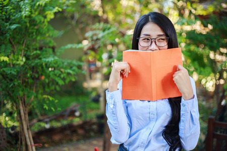 portrait woman with a book in the garden