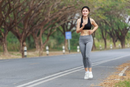 beautiful fitness woman running in the parkの写真素材