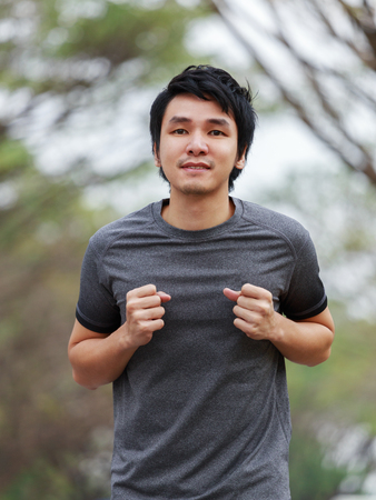 young fitness man running in the parkの写真素材