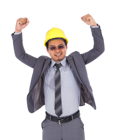 Happy young engineer celebrating with arms raised, concept of successful, isoalted on white backgroundの写真素材