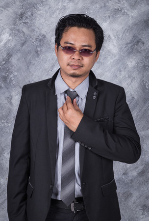 business man in a suit fixing his tieの写真素材