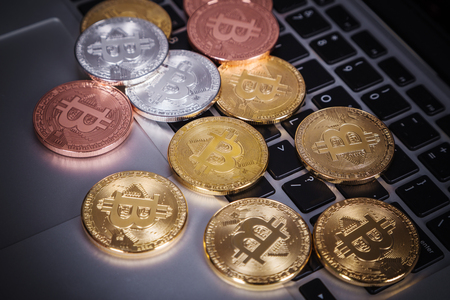 bitcoin on a laptop keyboard computer backgroundの写真素材