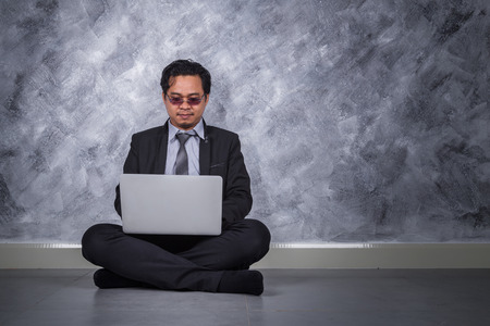 young business man sitting and using laptop の写真素材
