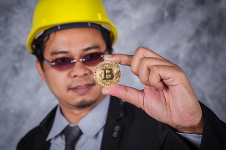bitcoin in hand of engineer with suitの写真素材
