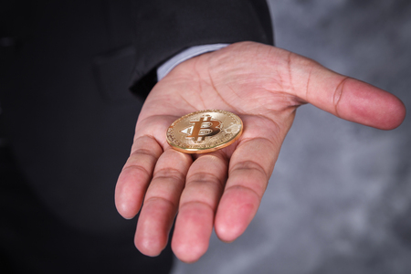 bitcoin in hand of business man with suitの写真素材
