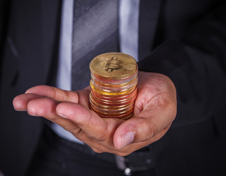 bitcoin in hand of business man with suitの写真素材