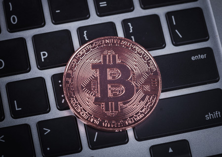 bitcoin on a laptop keyboard computer background