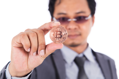 man holding bronze bitcoin in hand isolated on a white backgroundの写真素材