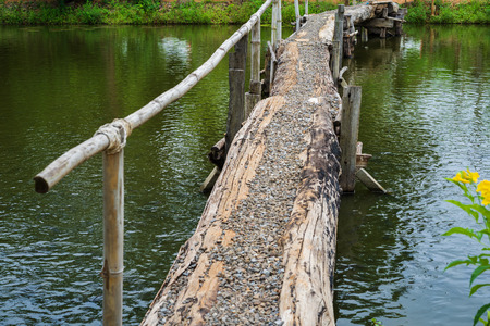 walking bridge across small riverの写真素材
