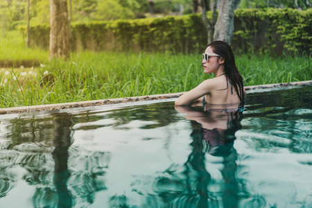 happy beautiful woman in the swimming pool 