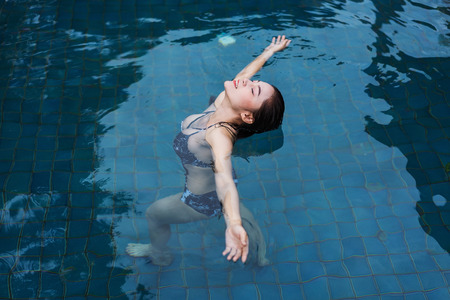 happy beautiful woman in the swimming pool 