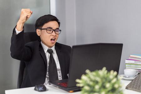 happy successful young business man using laptop computerの写真素材