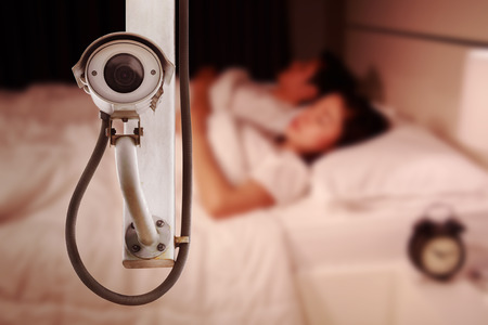CCTV Camera or surveillance operating with couple sleeping in bedroomの写真素材
