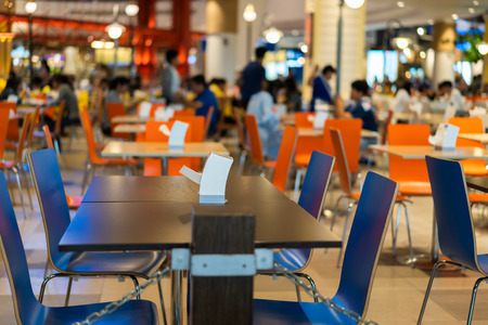 Tables and chairs on food court supermarketの写真素材
