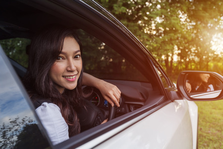 happy young woman in a carの写真素材