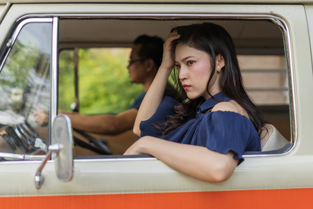 stressed woman sitting inside a vintage car