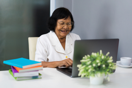 happy senior woman working on laptop computerの写真素材