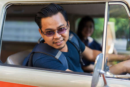 happy young man in vintage van