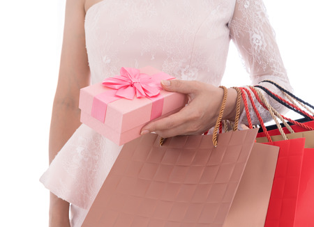 woman holding gift box and shopping bag isolated on a white backgroundの写真素材