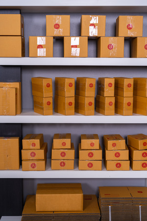 Parcels on shelf ready for shipment to client in the home officeの写真素材
