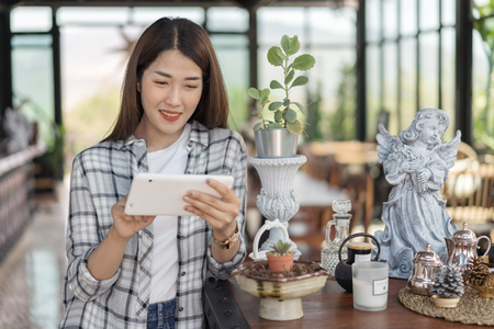 happy woman using digital tablet in a cafeの写真素材