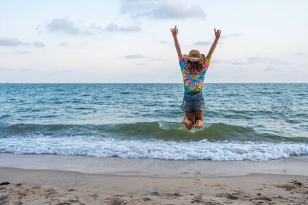 woman enjoy and jumping on the sea beachの写真素材