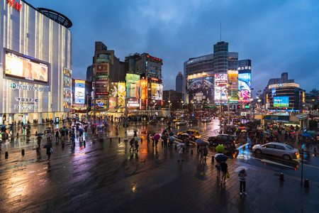 Taipei, Taiwan- 8 June, 2019: traffic and people walking on crosswalk at Ximending with falling rain in Taipei, Taiwan. Ximending is the famous fashion, night Market and street food in Taipei.のeditorial素材