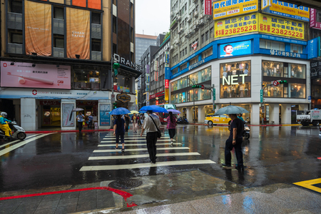 Taipei, Taiwan- 11 June, 2019: people crossing street in Ximen district with falling rain at Taipei, Taiwanのeditorial素材