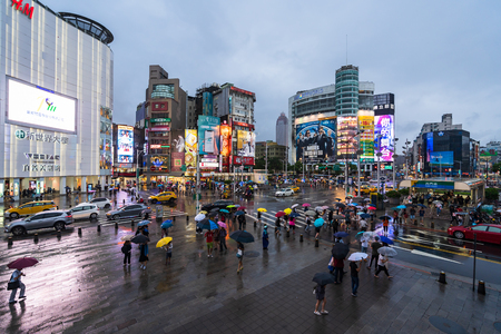 Taipei, Taiwan- 8 June, 2019: traffic and people walking on crosswalk with falling rain at Ximending in Taipei, Taiwan. Ximending is the famous fashion, night Market and street food in Taipei.のeditorial素材
