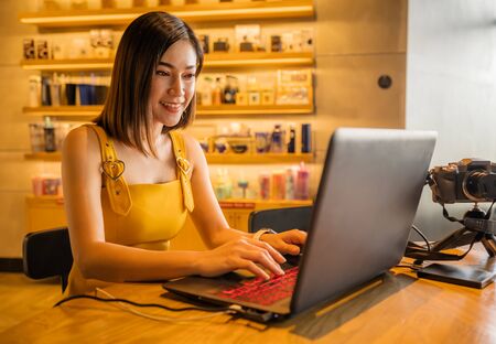 happy woman using laptop computer in a cafe