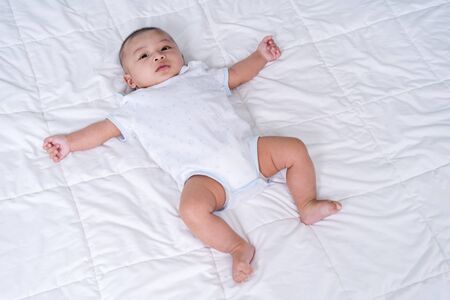 little cheerful baby on a bed