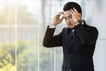 young stressed business man thinking about problem in office