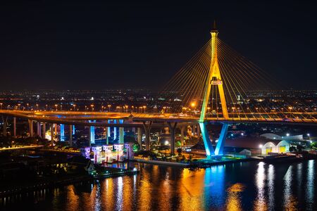 Bhumibol suspension bridge cross over Chao Phraya River at night in Bangkok city, Thailandの写真素材