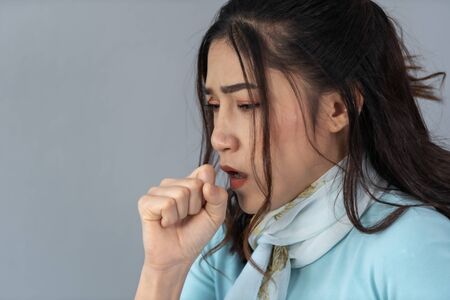 sick young woman is coughing の写真素材
