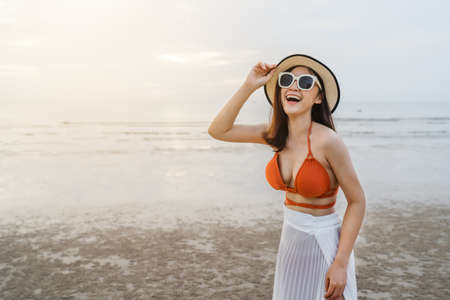 cheerful woman in bikini enjoying on the sea beachの写真素材