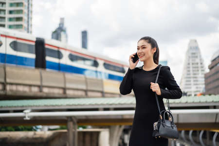 happy business woman talking with mobile phone in the cityの写真素材